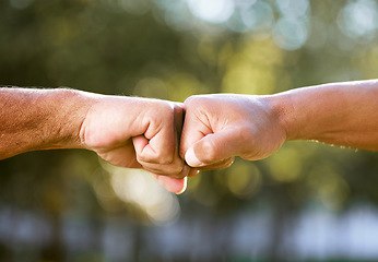 Image showing Fist bump, support and team building outdoor with solidarity, power and nature with friends. Respect, people and hands together for trust, teamwork and motivation in park, garden or congratulations