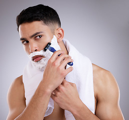 Image showing Beauty, shaving and foam with man in studio for hair removal, grooming and skincare. Cosmetics, self care and shower with face of male model on gray background for cleaning, razor blade and product