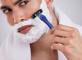 Image showing Hair removal, shaving and foam with man in studio for beauty, grooming or skincare. Cosmetics, self care and shower with face of male model and razor blade on gray background for cleaning and product