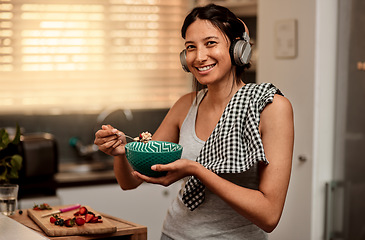 Image showing Headphones, eating breakfast and portrait of woman in kitchen with strawberry. Face headphone, food and happy female person with healthy fruit while listening to audio music, sound or radio podcast.