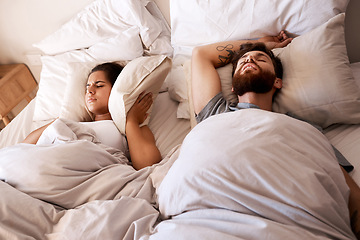 Image showing Bed, snoring and sleeping couple, frustrated woman or person with husband noise, problem and cover ears with pillow. Sleep, insomnia and relax girl with fatigue, tired and exhausted in home bedroom