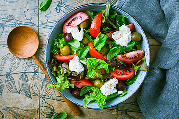 Image showing Burrata salad with tomatoes, olives and salad mix