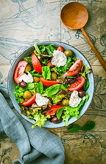 Image showing Burrata salad with tomatoes, olives and salad mix