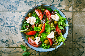 Image showing Burrata salad with tomatoes, olives and salad mix