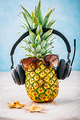 Image showing Summer concept - Pineapple hipster in sunglasses and headphones with melon and lemons, creative art fashionable vacation concept