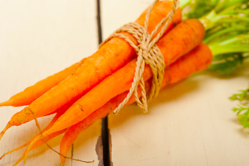 Image showing baby carrots bunch tied with rope