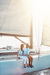 Image showing Couple, boat and adventure at sea for holiday during summer to relax on luxury or rich cruise. Ocean, vacation and people on yacht for outdoor travel and freedom to enjoy the sunshine together.