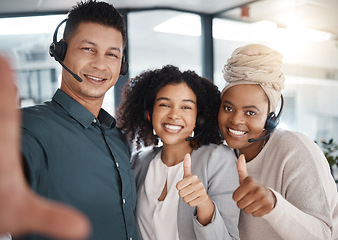 Image showing Selfie, thumbs up and call center friends in the office, posing for a photograph together in a customer service workplace. Portrait, motivation and support with consultant colleagues taking a picture