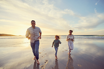 Image showing Mother, father and girl on beach at sunset for family holiday, summer vacation and weekend. Nature, travel and happy mom, dad and child running in ocean waves for bonding, playing and quality time