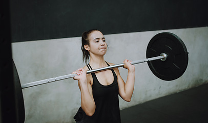 Image showing Weightlifting, fitness and woman lifting barbell in gym for training, exercise and intense workout. Deadlift, strong muscle and female body builder lift weights for challenge, wellness and strength