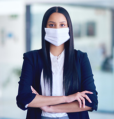 Image showing Business woman, face mask portrait and arms crossed with company attorney and serious. Worker, young female employee and professional lawyer in law firm at office with modern office and safety