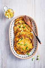 Image showing Homemade potato pancakes with cabbage salad and green onions