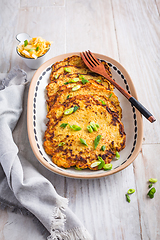 Image showing Homemade potato pancakes with cabbage salad and green onions