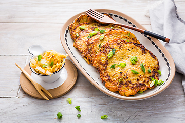 Image showing Homemade potato pancakes with cabbage salad and green onions