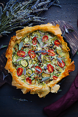 Image showing Delicious vegetarian summer quiche with zucchini, tomato, mushrooms, sage and lavender with phyllo pastry