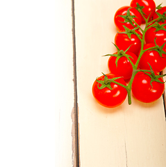 Image showing fresh cherry tomatoes on a cluster