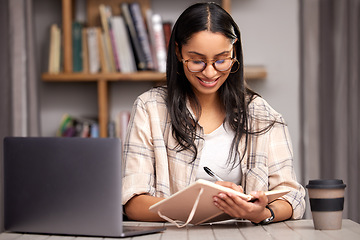 Image showing Laptop, writing and education with a student woman in a university library to study for a final exam. Technology, learning and notebook with a young female college pupil reading research material