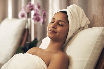 Image showing Spa, woman and relax with eyes closed for calm, zen and peace for physical therapy, health and wellness. Female customer with smile, luxury and towel for a holistic massage and hospitality at a salon