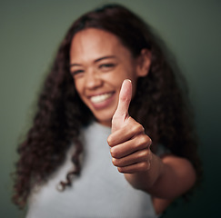 Image showing Woman, thumbs up and hand gesture with emoji and agreement, approval and feedback isolated on green background. Yes, like and thank you with happy female person, OK sign and support closeup in studio