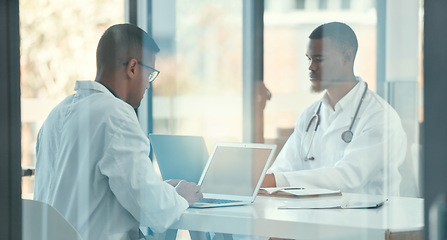 Image showing Meeting, laptop and team of doctors for healthcare coworking, discussion and online management. Working, typing and medical people on computer, telehealth and research behind glass window in office