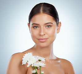 Image showing Skincare, face and woman with daisy flower in studio isolated on a white background. Portrait, natural plant and female model with spring floral for makeup cosmetics, beauty treatment and wellness.