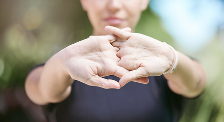 Image showing Fitness, runner or person stretching hands for workout or body movement while relaxing on break. Closeup, hand or blurry athlete in exercise training warm up for flexibility or wrist mobility in park