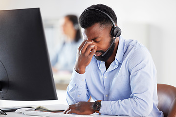 Image showing Mental health, man call center agent with headache and headset with computer at his desk in a modern workplace office. Telemarketing or consultant, stress or burnout and male person at workspace