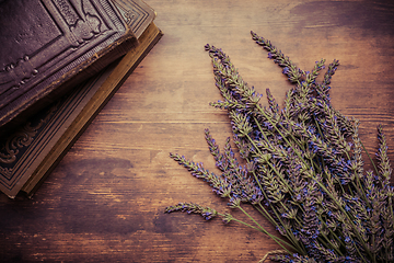 Image showing Vintage background with bunch of lavender a old books on wooden background