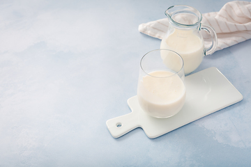 Image showing Buttermilk, kefir, yogurt with probiotics, ayran in glass and jar. Probiotic cold fermented dairy drink.