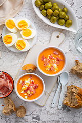 Image showing Salmorejo - raw tomato soup with ingredients on a kitchen table,  spanish cuisine for hot summer