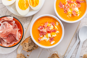 Image showing Salmorejo - raw tomato soup with ingredients on a kitchen table,  spanish cuisine for hot summer