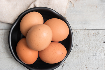 Image showing Eggs in black bowl