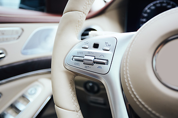 Image showing Control buttons on steering wheel. Car interior.