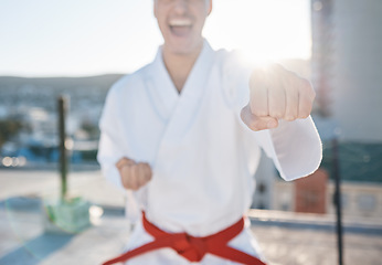 Image showing Karate, fitness and fight with a sports man in gi, training in the city on a blurred background. Exercise, discipline or power with a male athlete during a self defense workout for health closeup