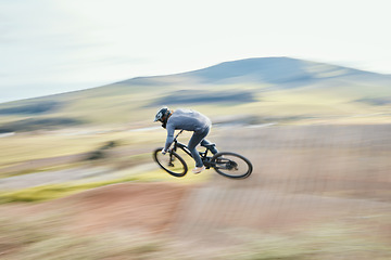 Image showing Sports, energy and man riding a bike in nature training for race, marathon or competition. Fitness, blur motion and male athlete biker practicing for an outdoor cardio exercise, adventure or workout.
