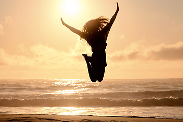 Image showing Freedom, jump and sunset with woman at beach for travel, celebration and winner. Success, summer and silhouette with person jumping in nature for inspiration, energy and purpose with mockup space