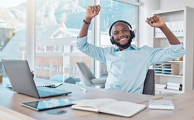 Image showing Music, black man in office with headphones, dance and enjoying work with radio streaming app. Excited African businessman at desk with earphones, excited dancing and fun working on startup report.