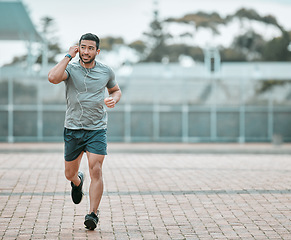 Image showing Sports, exercise and man running with earphones for music, radio or podcast for motivation. Fitness, energy and athlete runner doing outdoor cardio workout for race, competition or marathon training.