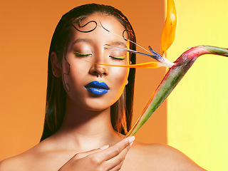 Image showing Makeup, flowers and face of woman with cosmetics in studio for salon, eye shadow and beauty. Aesthetic, cosmetology and female person with blue lipstick and plant for glamour, luxury style and glow