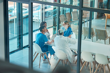 Image showing Healthcare, doctors and team meeting with a laptop for a discussion, planning or research at table. Men and women medical group talking about communication strategy, virus or surgery in a hospital