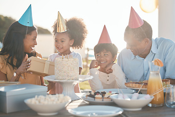 Image showing Birthday, parents and children with cake in park for event, celebration and party outdoors together. Family, social gathering and mother, father with kids at picnic with cake, presents and surprise