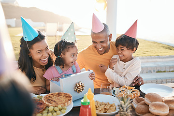 Image showing Happy birthday, love and family outdoors for celebration, party and present, laugh and excited. Parents, children and gift for girl child at special event, smile and celebrating with food outside