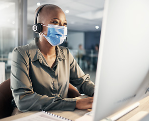 Image showing Face mask, call center and a woman at computer with headset for safety compliance and health. African female agent at pc for customer service, help desk or crm with protection from covid or bacteria