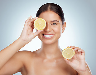 Image showing Face, skincare and smile of woman with lemon in studio isolated on a white background. Portrait, natural and female model with fruit for vitamin c, nutrition or healthy diet, wellness or cosmetics.