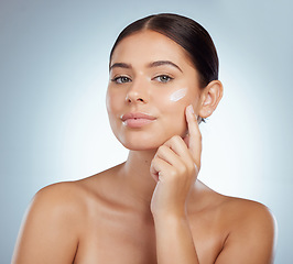 Image showing Skincare, face and woman with cream in studio isolated on a white background. Portrait, dermatology lotion and female model apply beauty cosmetics, sunscreen or moisturizer product for skin health.