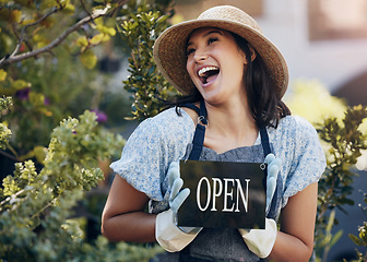 Image showing Happy, nursery and open with a woman holding a sign outside of shop for gardening or landscaping. Small business, garden center and an excited young female entrepreneur opening her new floral store