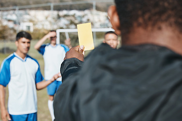 Image showing Sports team, yellow card and soccer referee outdoor on field for competition or game foul or rules. Football player, athlete club and person with paper in hand for warning, penalty or punishment