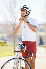 Image showing Bicycle, helmet and man cycling in a competition, fitness training or marathon or sports adventure with blue sky. Gear, athlete and safety in outdoor cycle, bike ride or exercise in nature or park