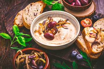 Image showing Whipped feta cheese dip with garlic, olives, lemon and caramelized onions. 