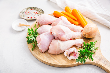 Image showing Raw chicken drumsticks with vegetables ans spices prepared for c